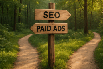 Wooden signpost in a forest with arrows pointing to "SEO" and "Paid Ads," symbolizing the choice bloggers face in building traffic.