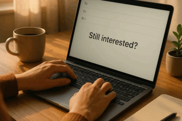 Person typing “Still interested?” on a laptop screen while writing a re-engagement email.